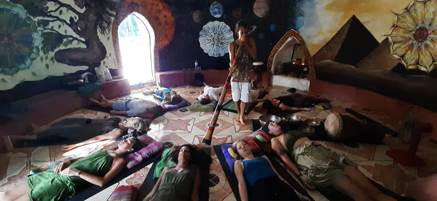 A full circle of participants resting during a session