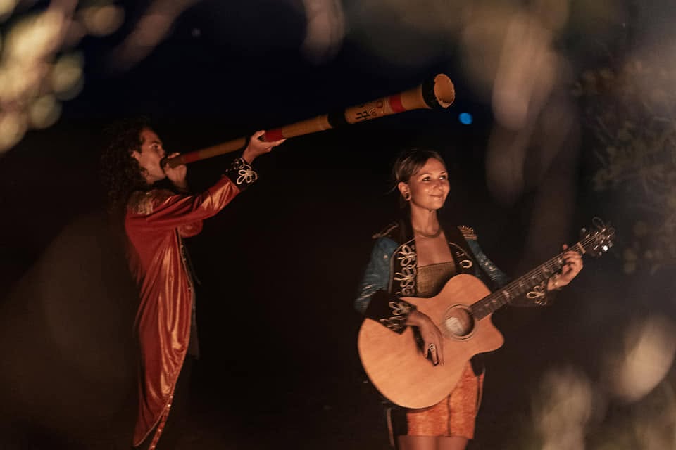 Oliv and Anna playing didgeridoo and guitar at night